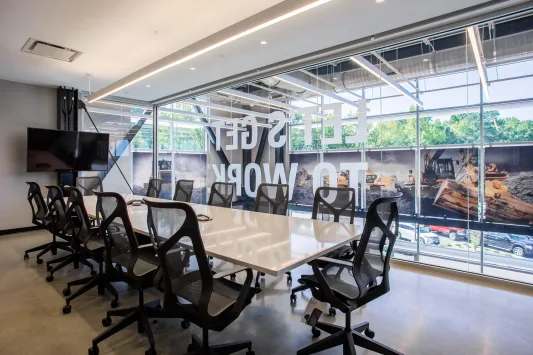 A conference room with a table and chairs inside the Carter Machinery Richmond Office.