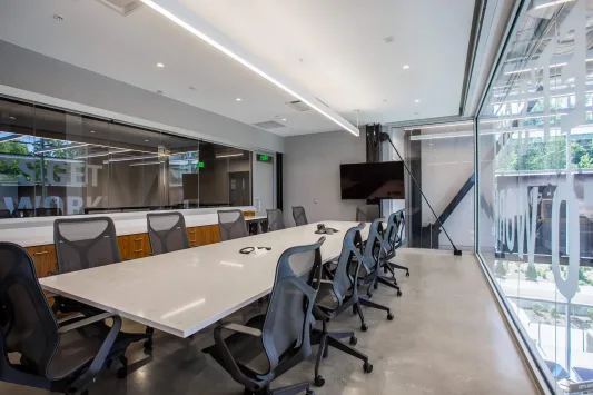 A conference room with a table and chairs inside the Carter Machinery Richmond Office.