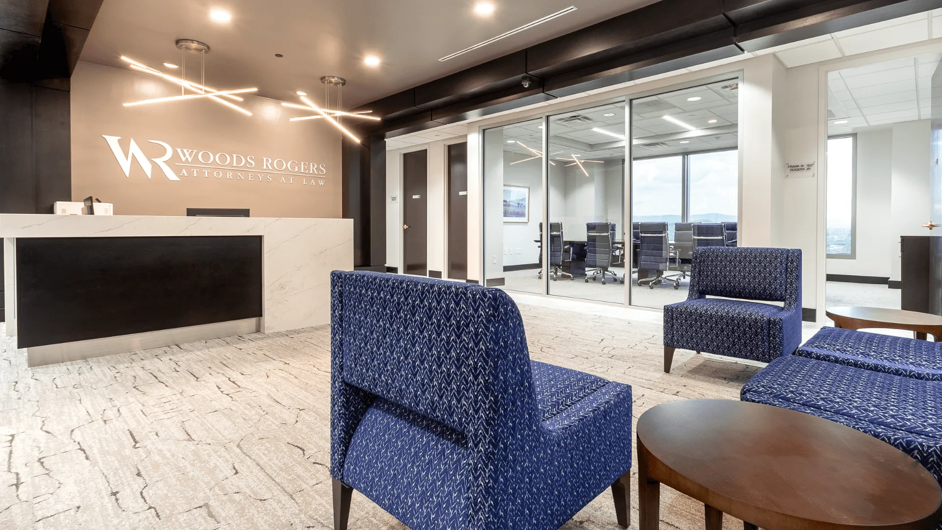 The service desk, a conference room, and chairs inside the office of Woods Rogers in Roanoke, Virginia.