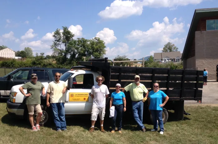 Lionberger team taking a picture in front of a white truck