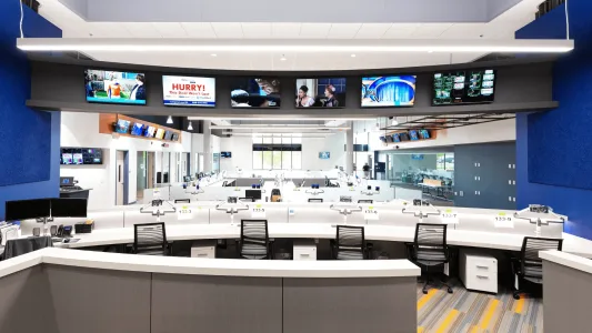 Producers' desks with monitors displaying the newscast in the WSLS newsroom in Roanoke, Virginia.